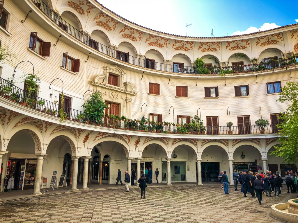 Plaza del Cabildo, a peaceful square surrounded by orange trees in Seville, Spain.